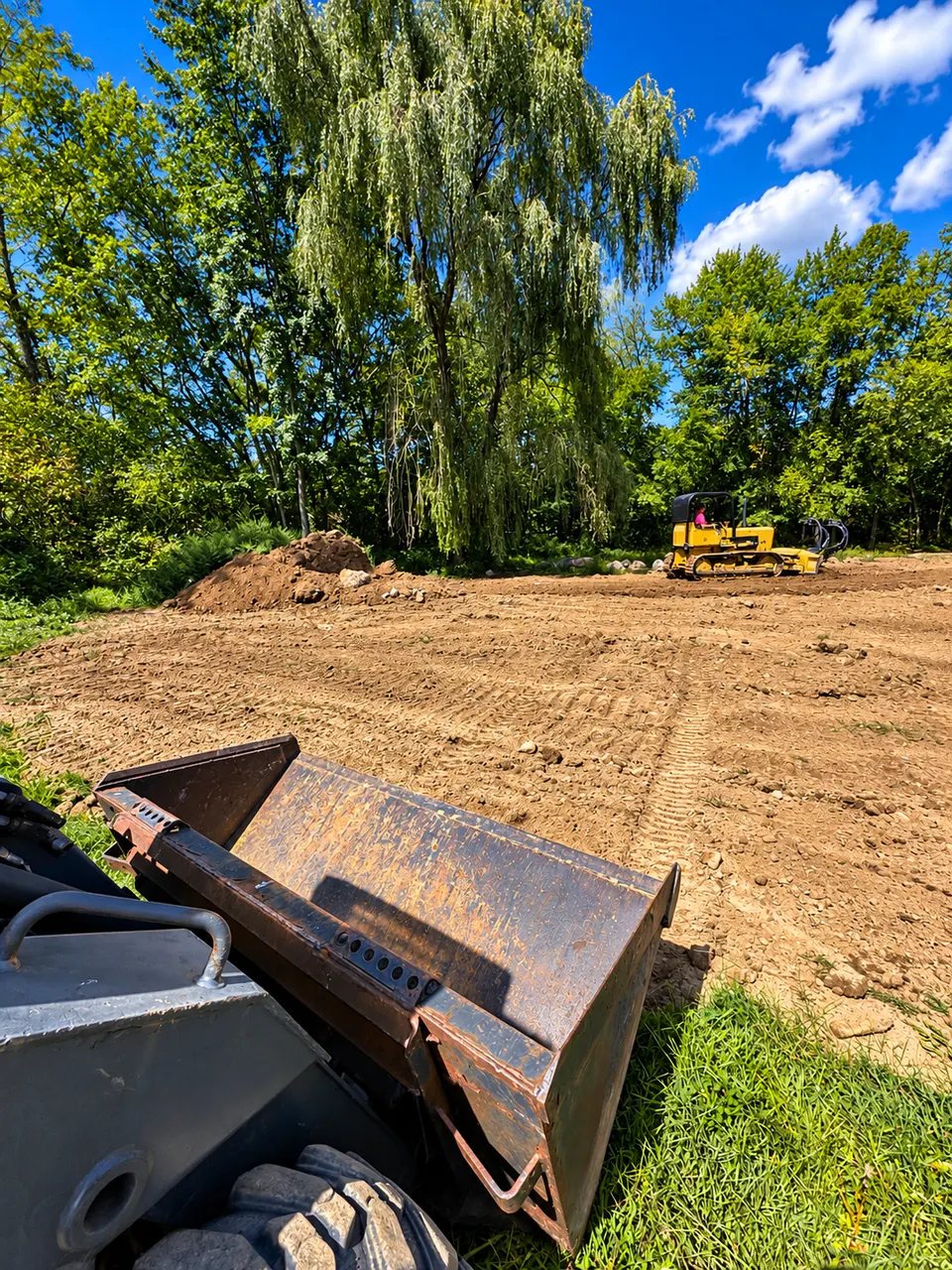 Earthmoving with a bulldozer and loader on a residential site